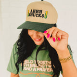 Two tone adjustable baseball cap with a cute corn pun that reads "Ahhh Shucks" featuring corn graphics.