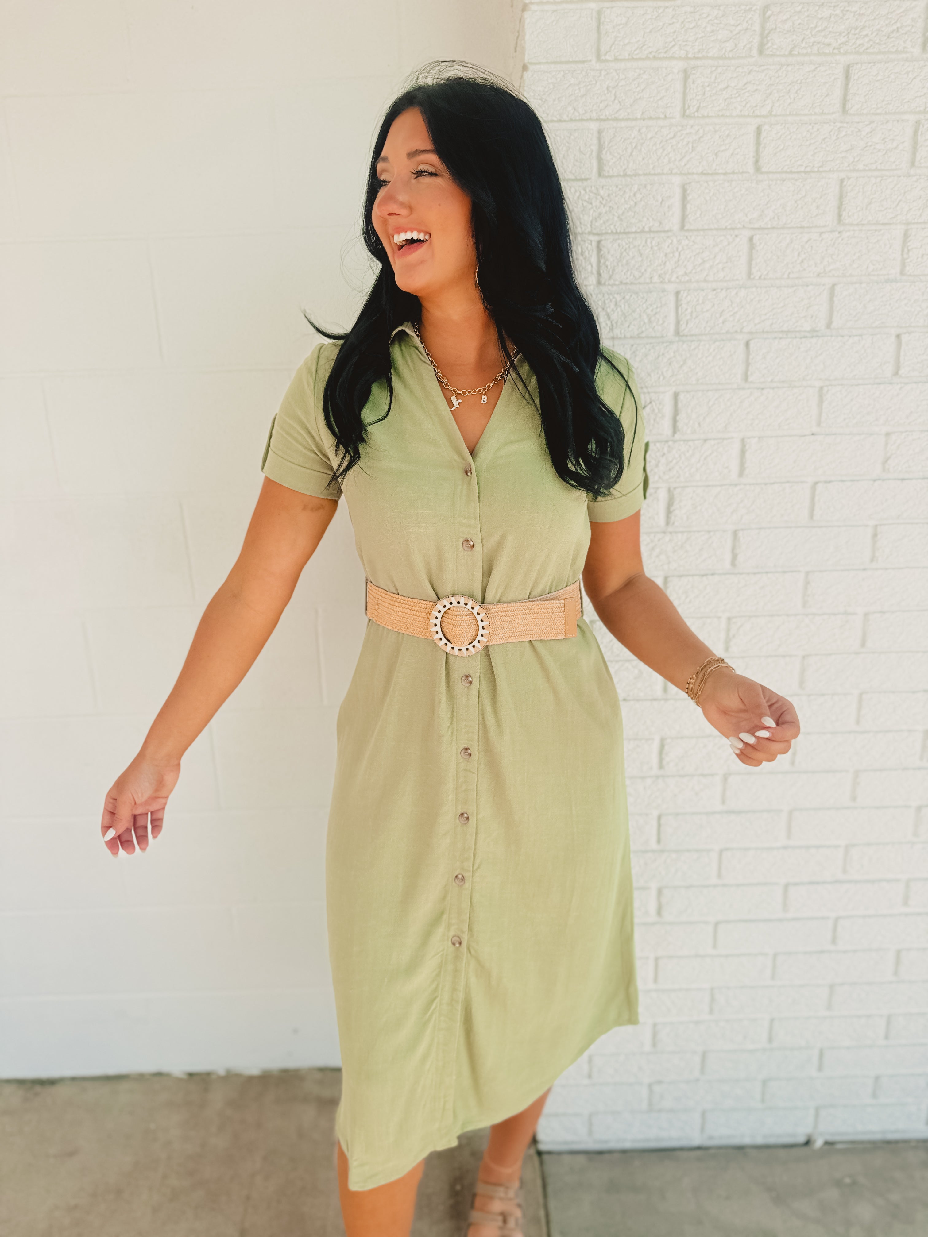 Olive green button down midi dress with v-neck, rolled short sleeves, and belt fro the waist.