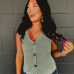 Forest green v-neck knitted sleeveless vest with chunky buttons.