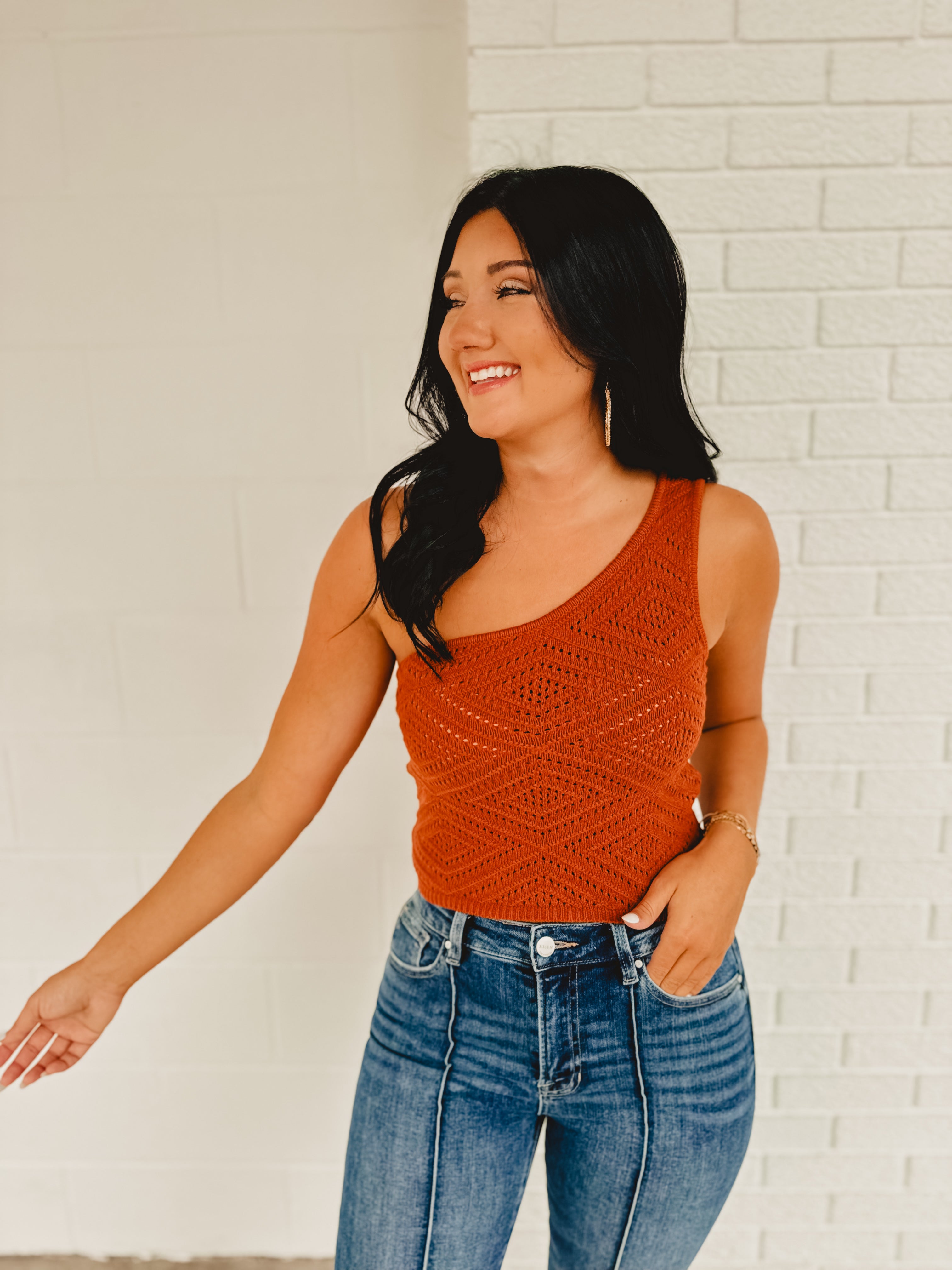 Cropped one shoulder knit crop top in the color rust.