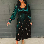 Dark green velvet floral embroidered maxi dress with front bows and smocked sleeve ends.