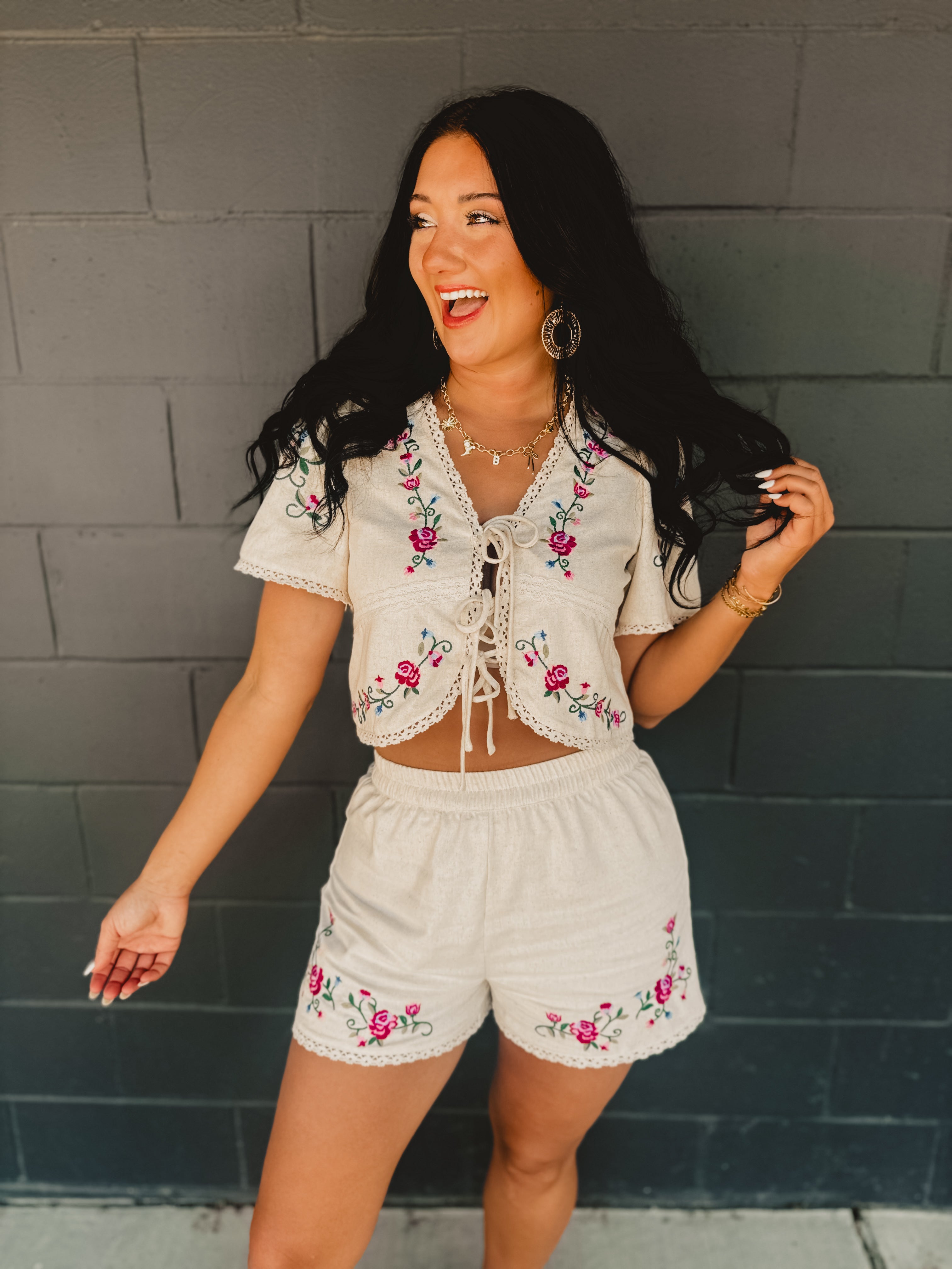 Short sleeved tie-up cropped blouse with floral embroidery and scalloped crochet details.