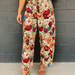 Bright colored floral jacquard barrel fit pants in multi with zip-up closure and pockets.
