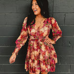 Long sleeved floral ruffle mini dress with an elastic waistband.