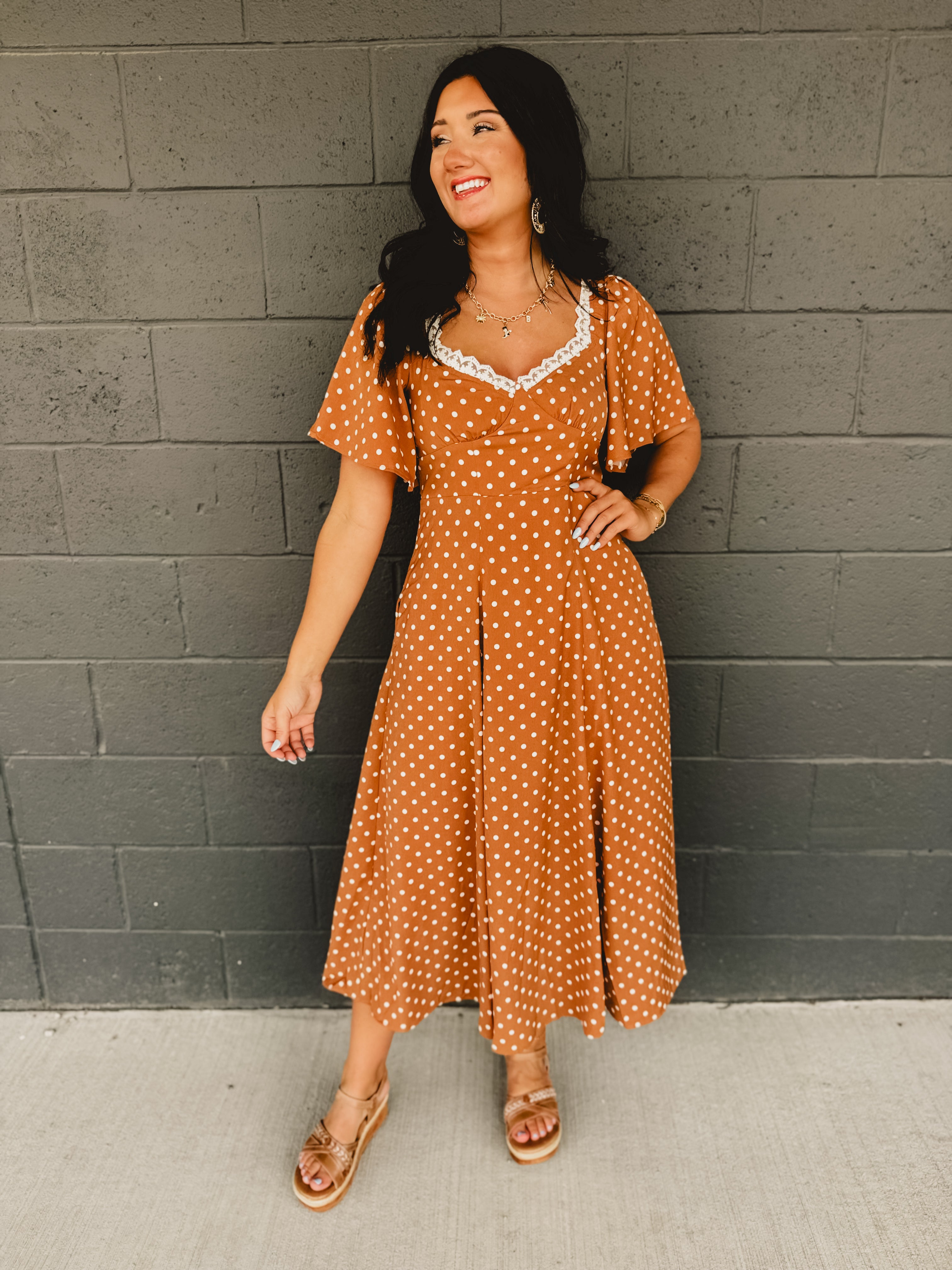 Sweetheart neckline short sleeved midi dress with back tie detail, polka dots, and hidden side pockets in the color Sepia(Camel).