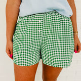 Green and white gingham printed boxer shorts with front button detail.