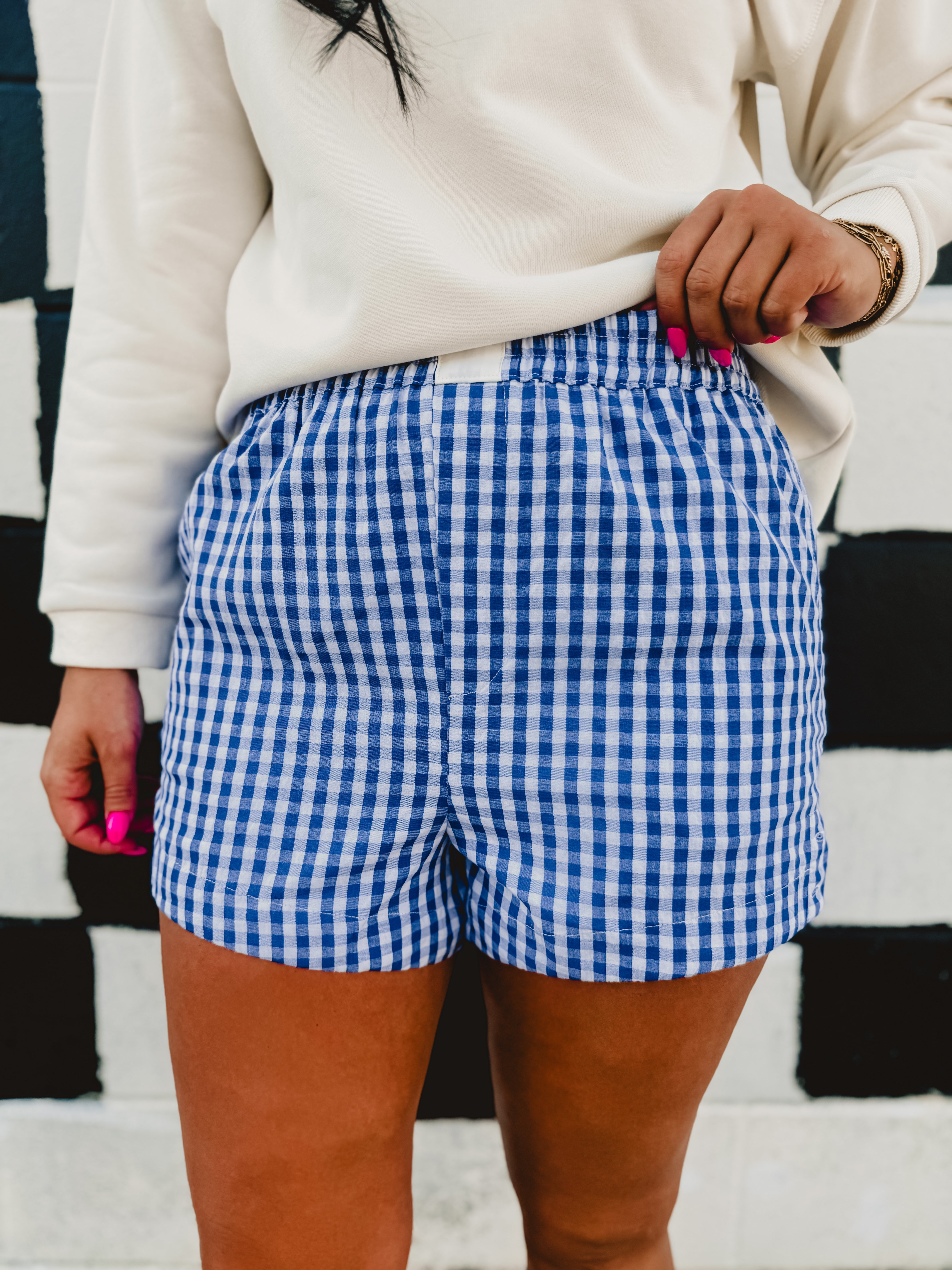 Blue/white gingham printed elastic waistband boxer shorts.
