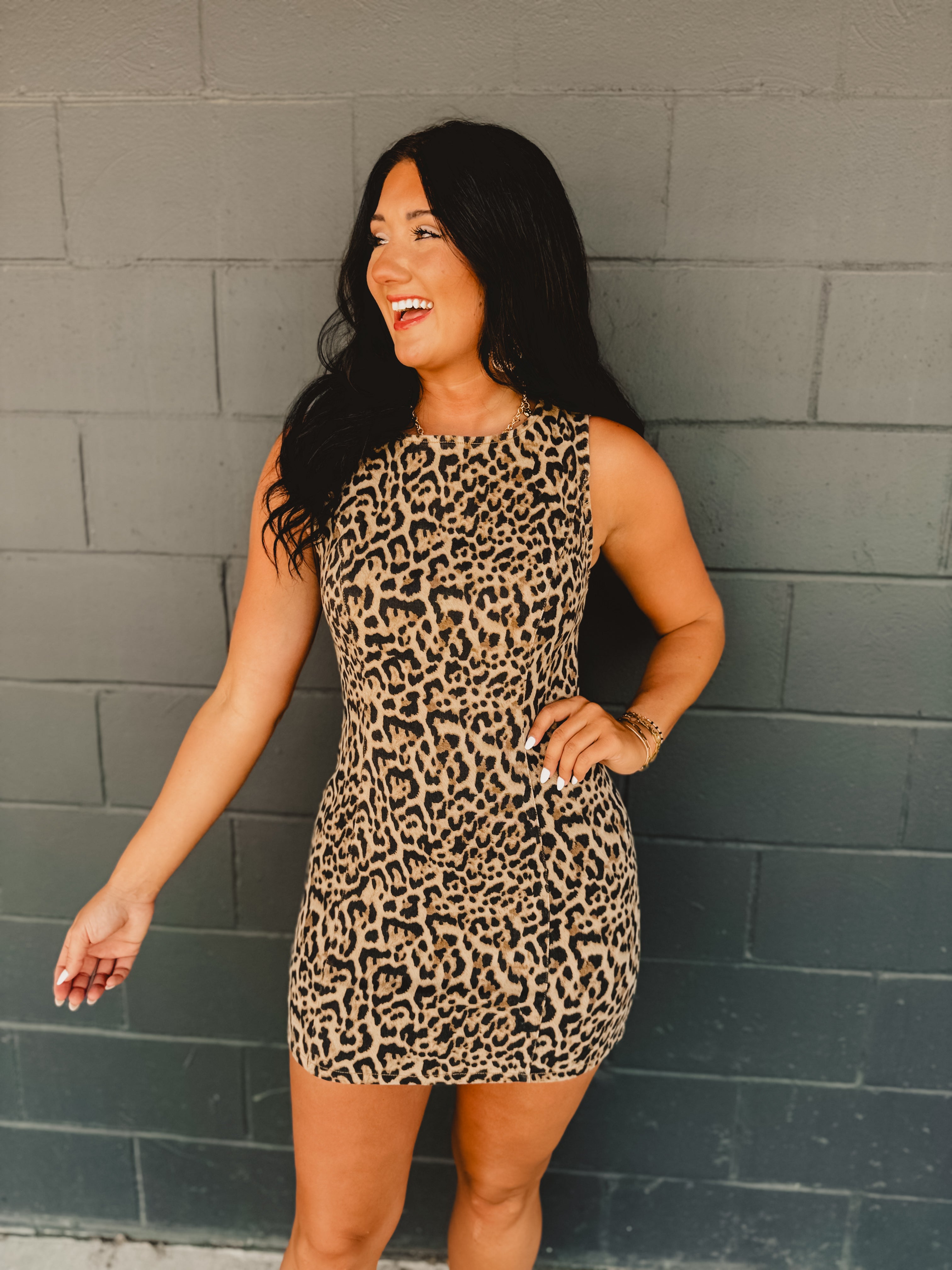 Leopard denim mini fitted dress with a boat neckline and zip-up closure.