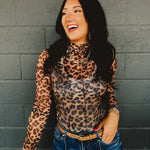 High mock neck long sleeve sheer leopard print top with ruffle hems and a front seam.