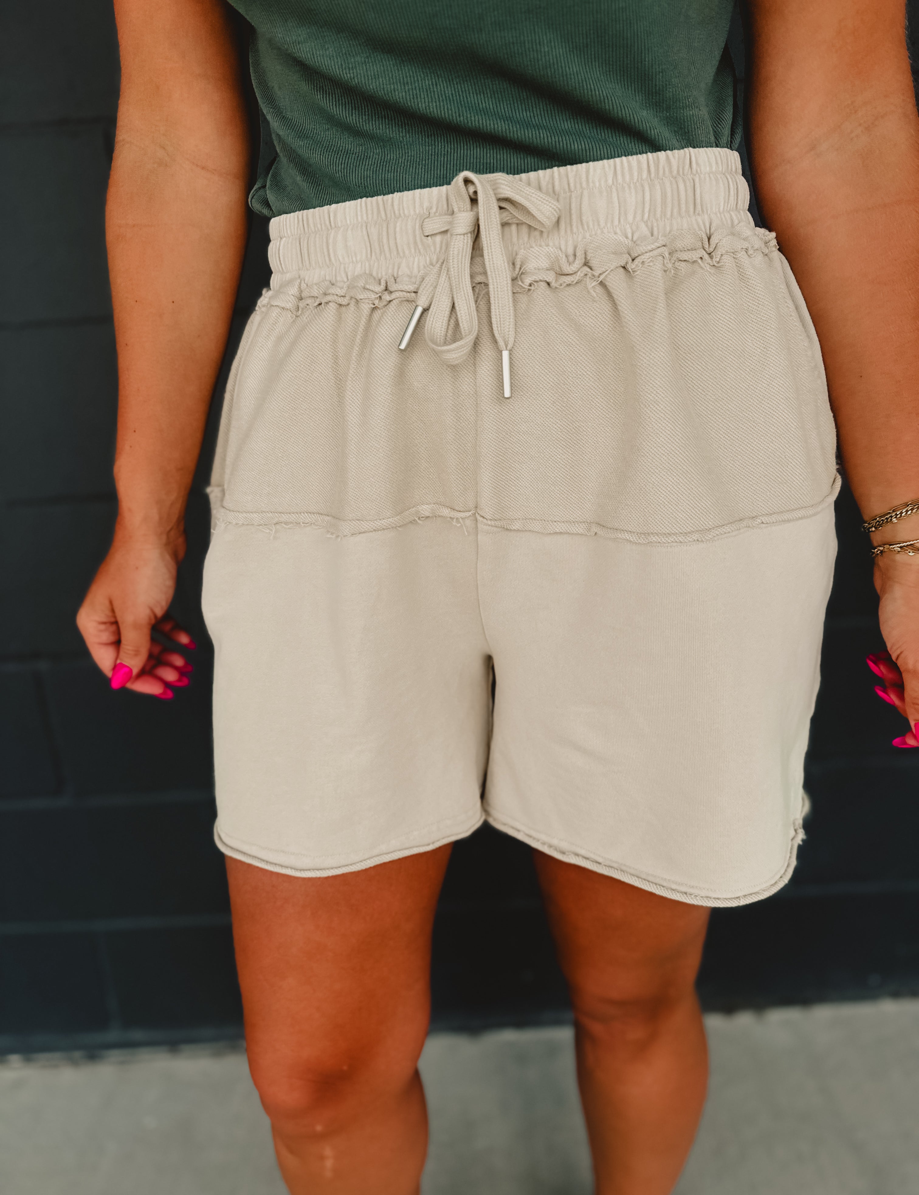 Contrast fabric mineral wash terry knit shorts with an elastic waistband and drawstrings in khaki.