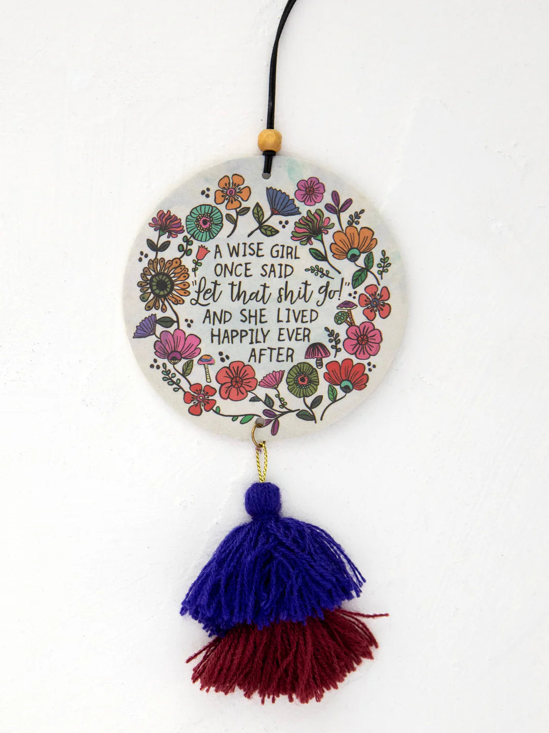 Natural Life car air freshener that reads "A wise girl once said "Let that shit go and she lived happily ever after" with double sided artwork and elastic string for hanging in the scent Ocean.