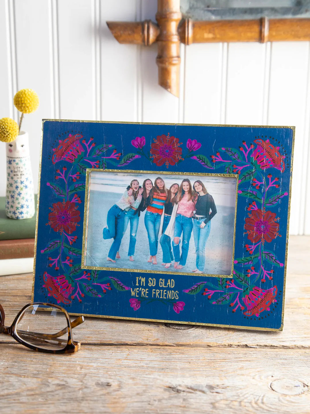 Decorative photo frame with floral designs and a photo inside, cute home decor.