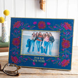 Decorative photo frame with floral designs and a photo inside, cute home decor.