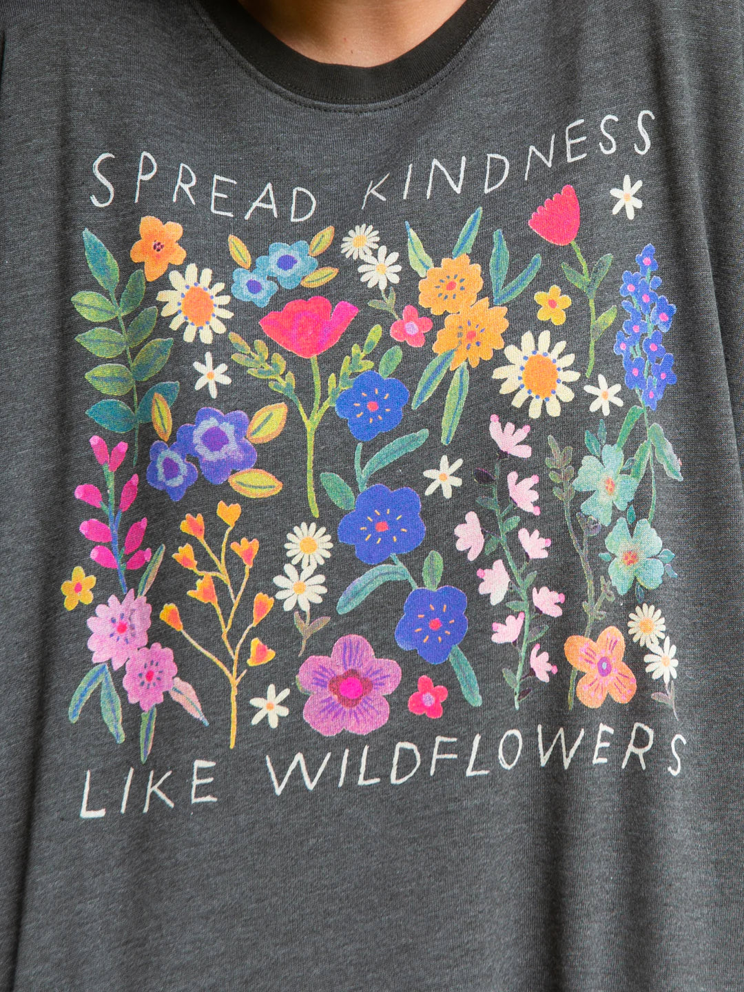 Natural Life long sleeve round neck sweatshirt that reads "Spread kindness like wildflowers," featuring side pockets and interior soft fleece.