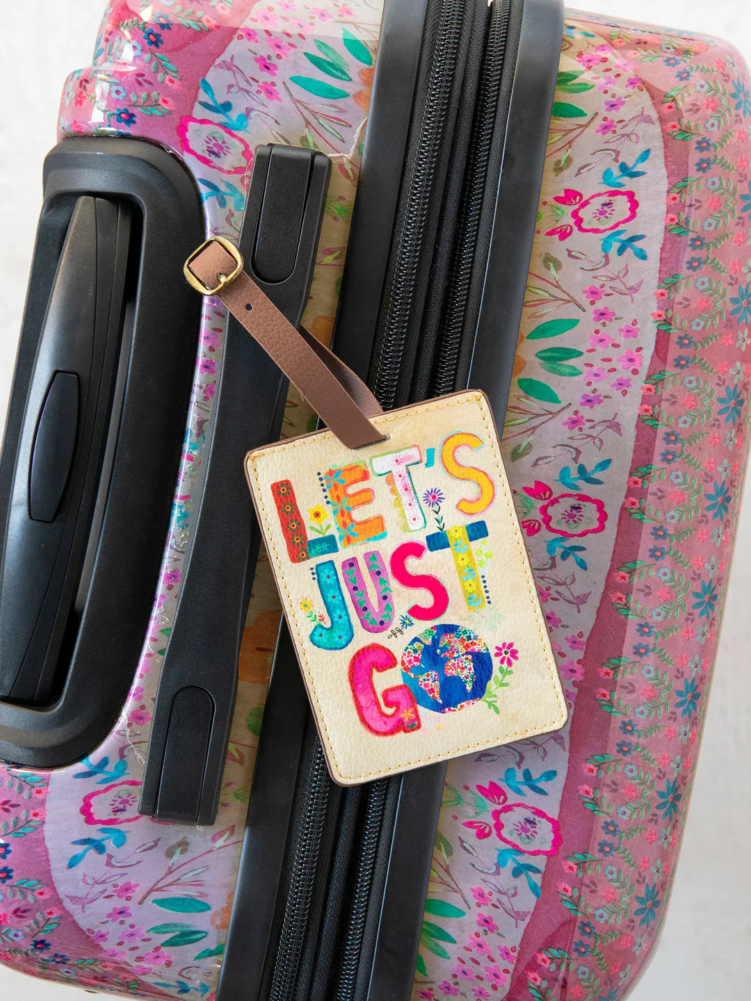 Vegan leather strap and buckle Natural Life luggage tag that reads "Let's Just Go."