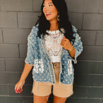 Denim holey open cardigan with white crochet pockets and a v-neck.