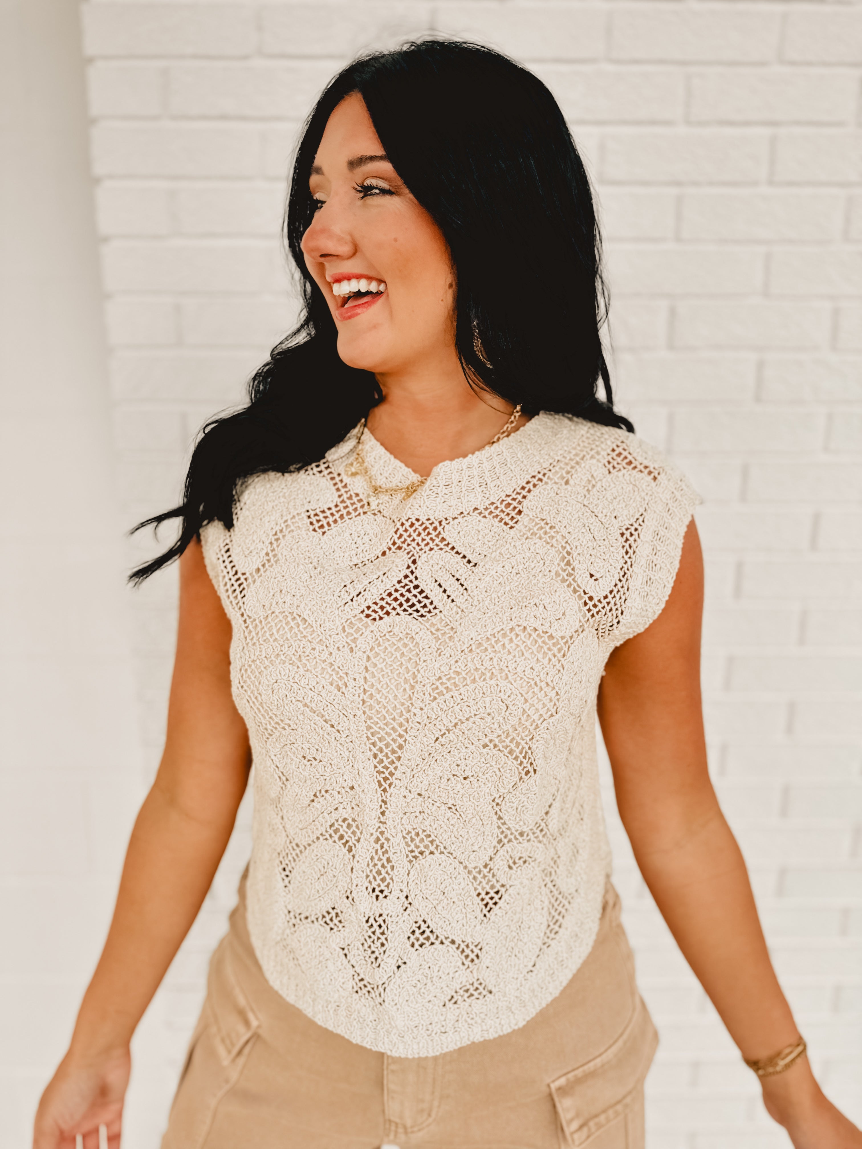 Round neck sleeveless crochet cutout top in natural.