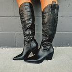 Zip-up below the knee tall black embroidered western boots with pointed toes and heels.