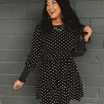 Polka dot ruffled mini dress with a mock neckline and long sleeves.