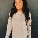 Ribbed brushed long sleeve top in taupe with a front pocket and exposed seams detail.