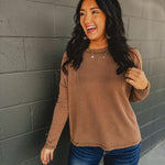 Ribbed raw edge long sleeve top in brown.