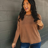 Ribbed raw edge long sleeve top in brown.
