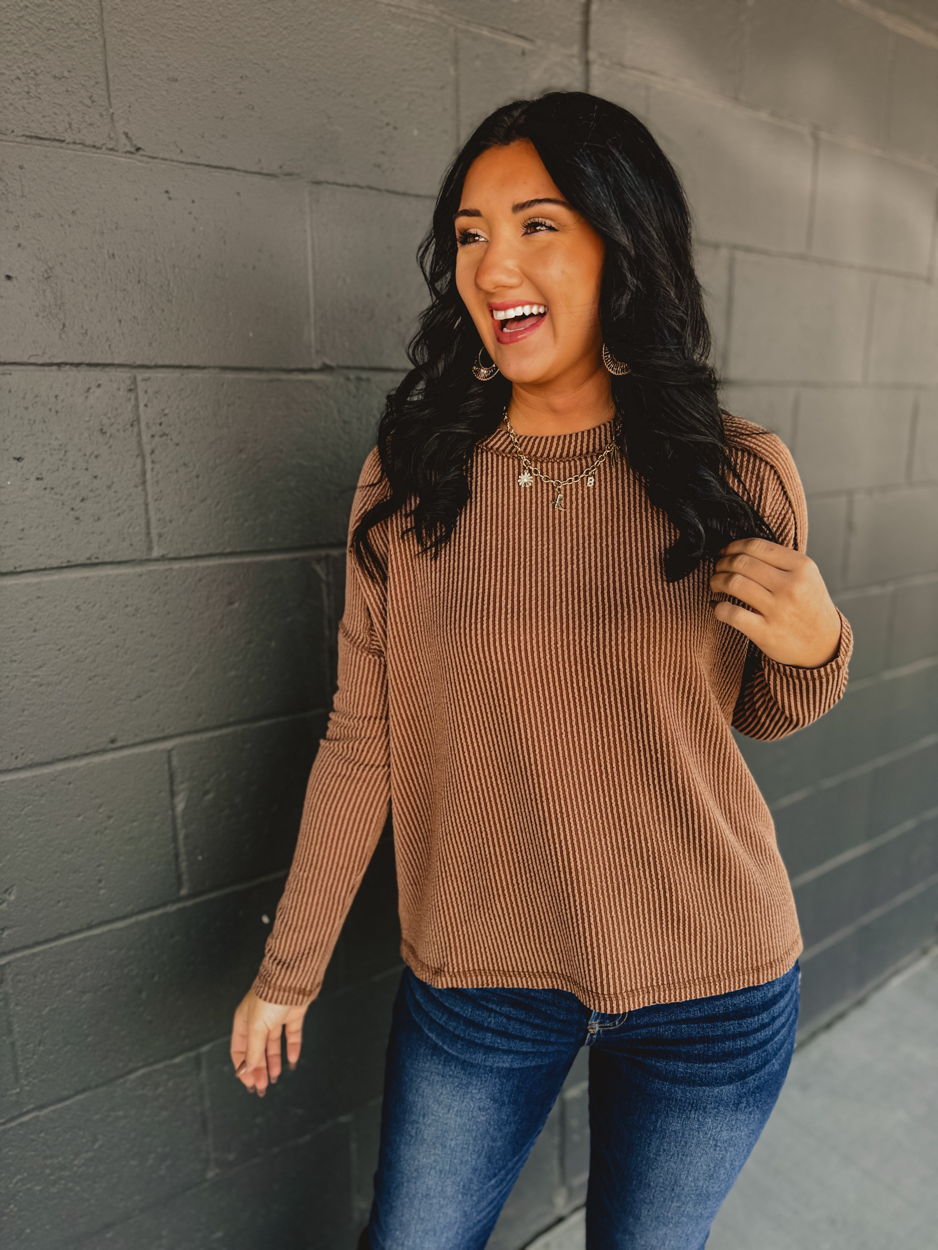 Ribbed raw edge long sleeve top in brown.