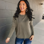 Ribbed exposed seam long sleeve top in dark olive.