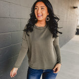 Ribbed exposed seam long sleeve top in dark olive.