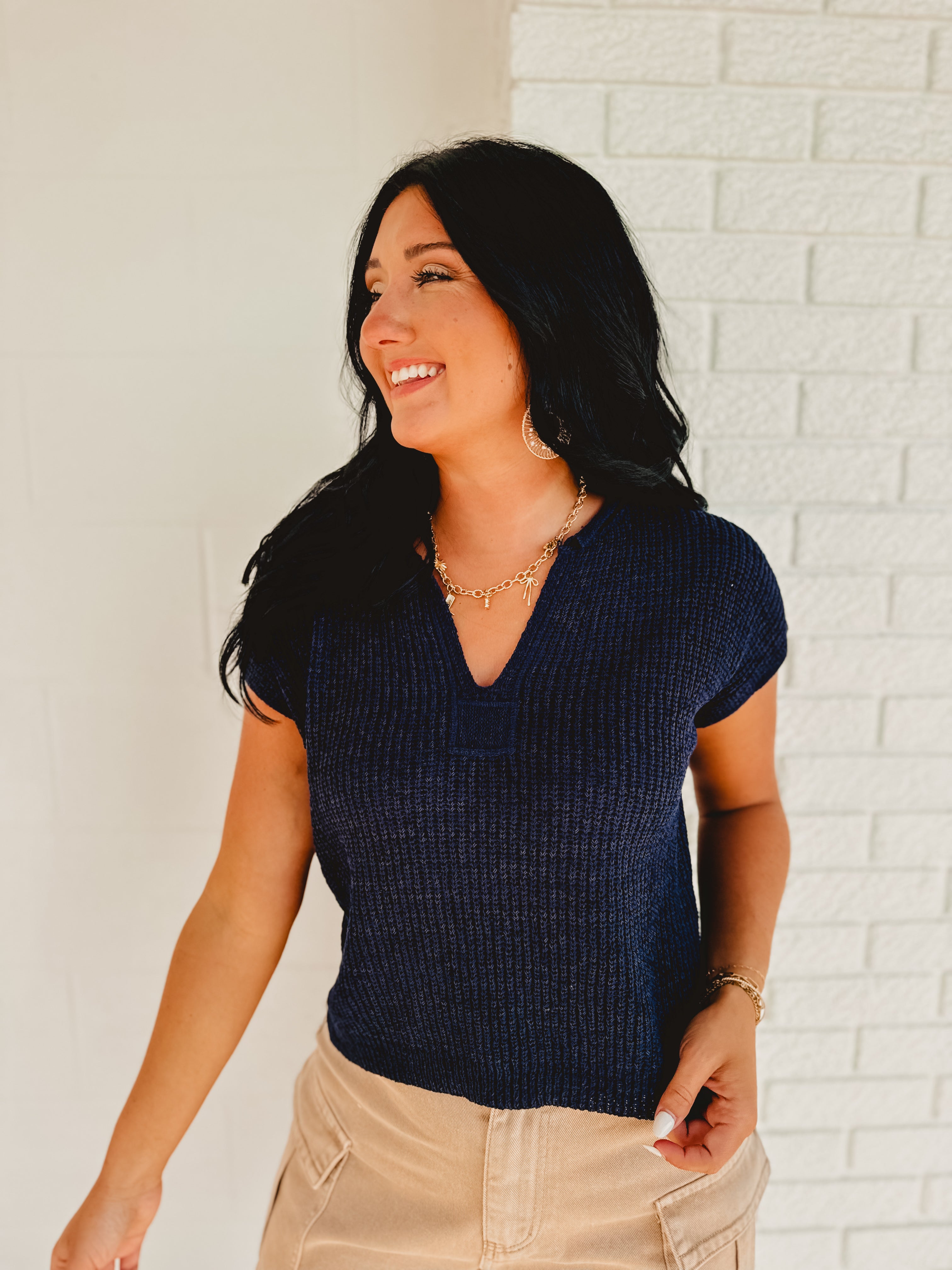 Split-neck short sleeve knit sweater top in the color navy.