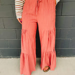 Tired textured wide leg pants with an elastic waistband and drawstrings in dried rose.