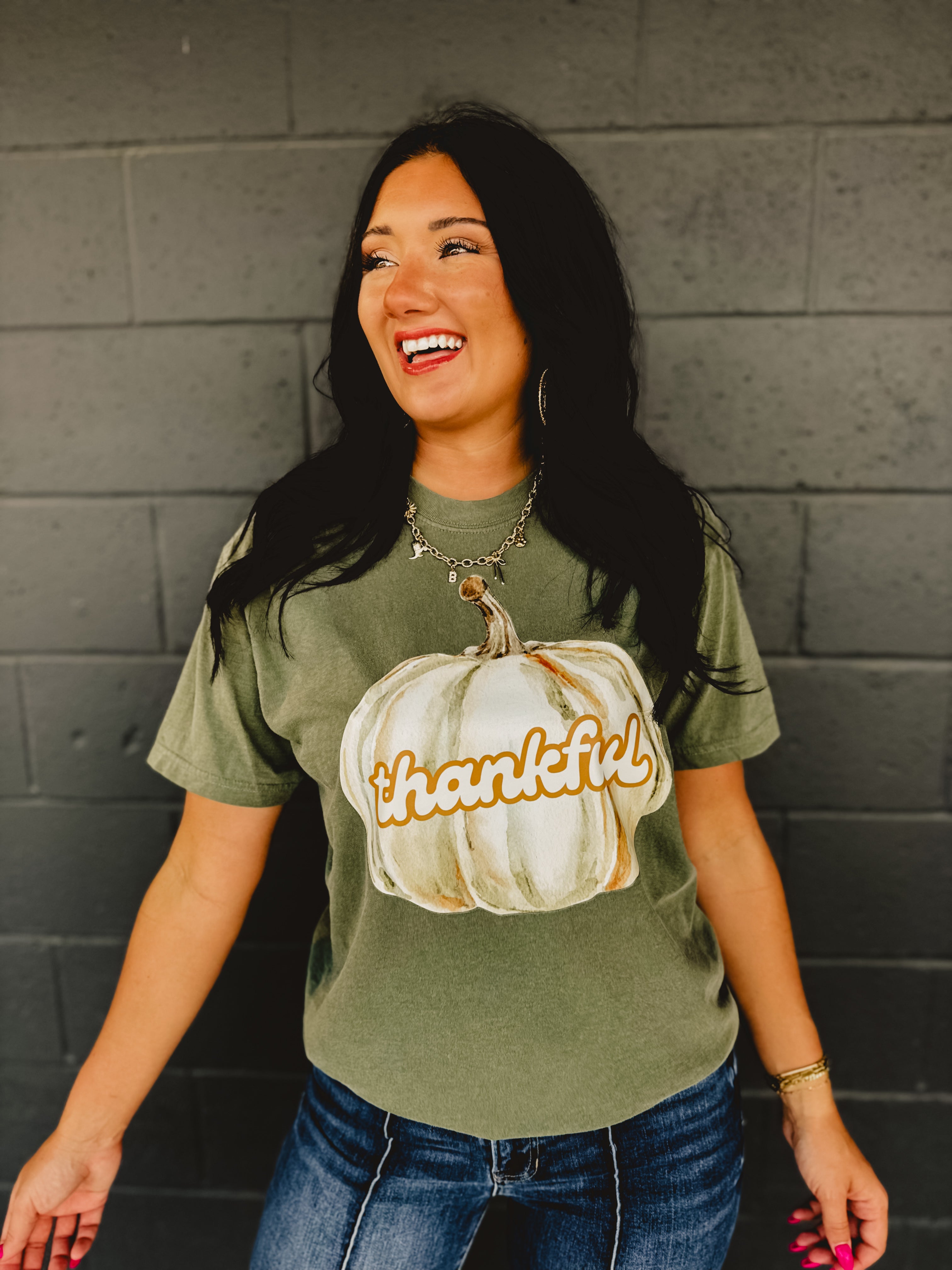 "Thankful" pumpkin autumn short sleeved graphic tee with a round neck and full length in moss green.