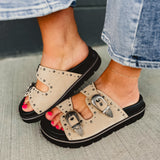Western buckle and studded taupe sandal with a black sole.