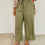Linen drawstring wide leg pants with an elastic waistband and front pockets.