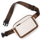 Compact waist/sling bag with zip up closure and adjustable strap in the color  white/brown.