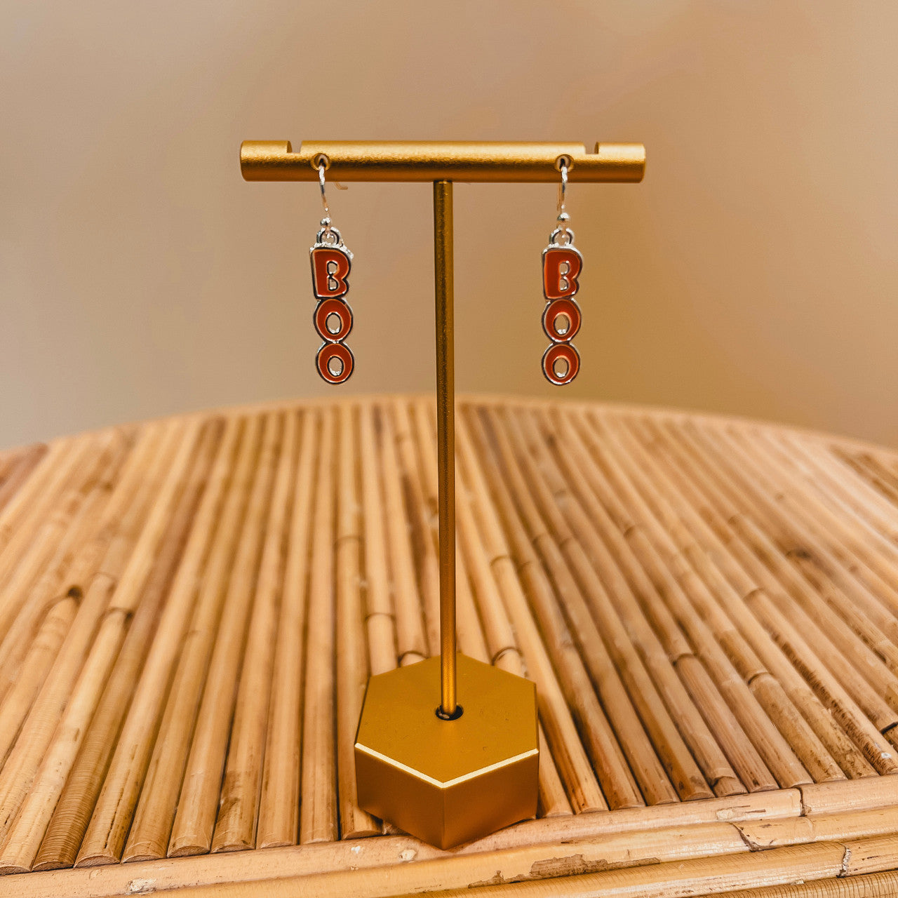 "Boo" silver and orange drop earrings.
