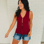 Sleeveless button-up sweater vest in the color cabernet.