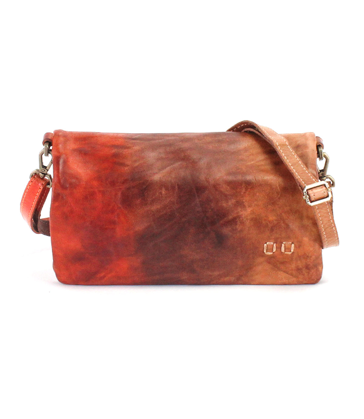 BedStu Cadence crossbody clutch in desert sunset tie dye, warm brown and red vegetable-tanned leather with an adjustable strap and metal clasp hardware