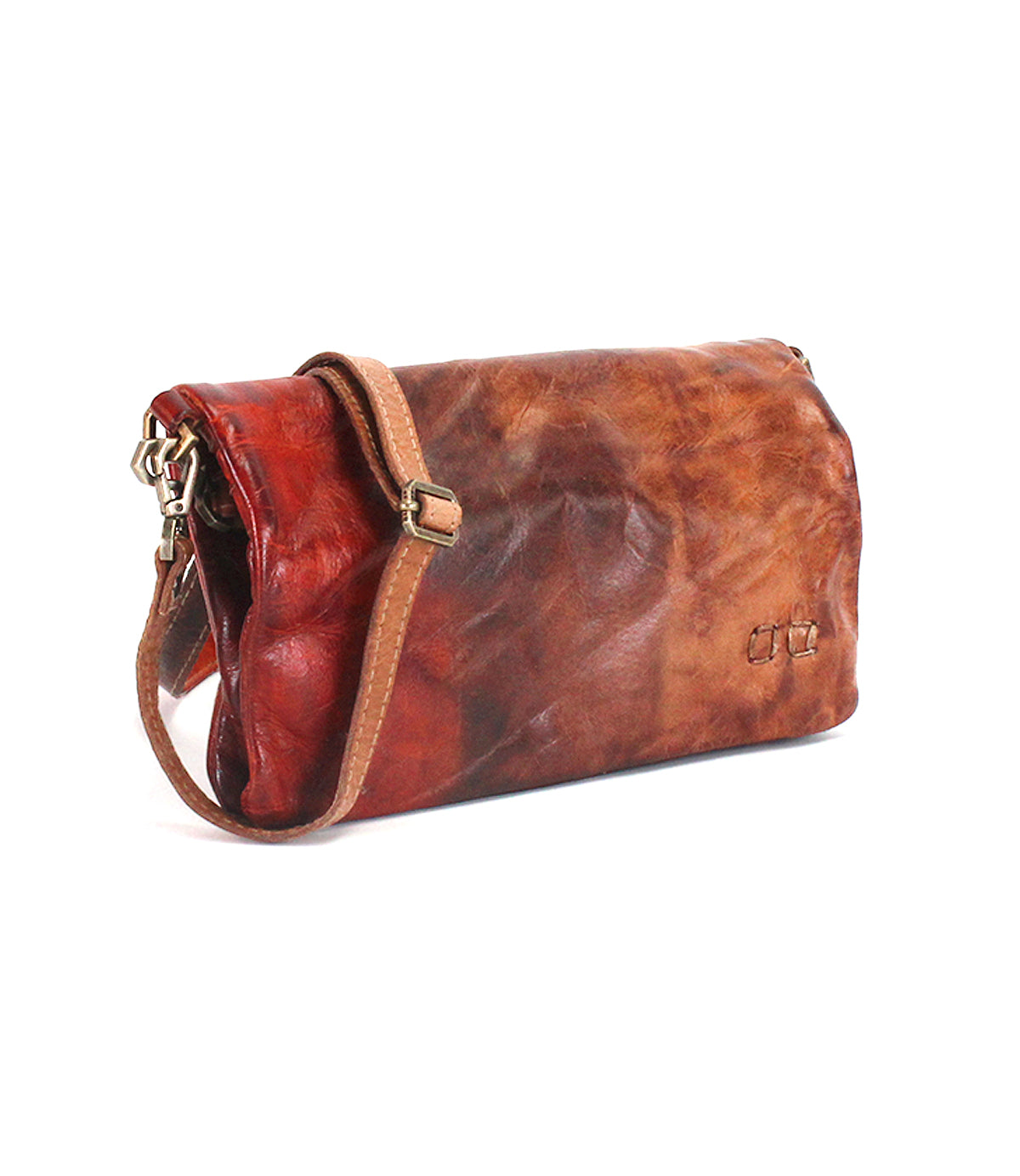 Desert sunset tie dye Cadence worn as a crossbody, showing the tan adjustable strap and embossed logo