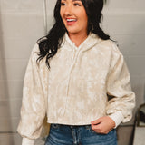 Camo cropped hooded top with drawstrings and oversized sleeves.