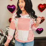 Checkered patchwork round neck long sleeve pullover top in pink and white.