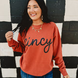 Long sleeve round neck orange Cincy sweatshirt.