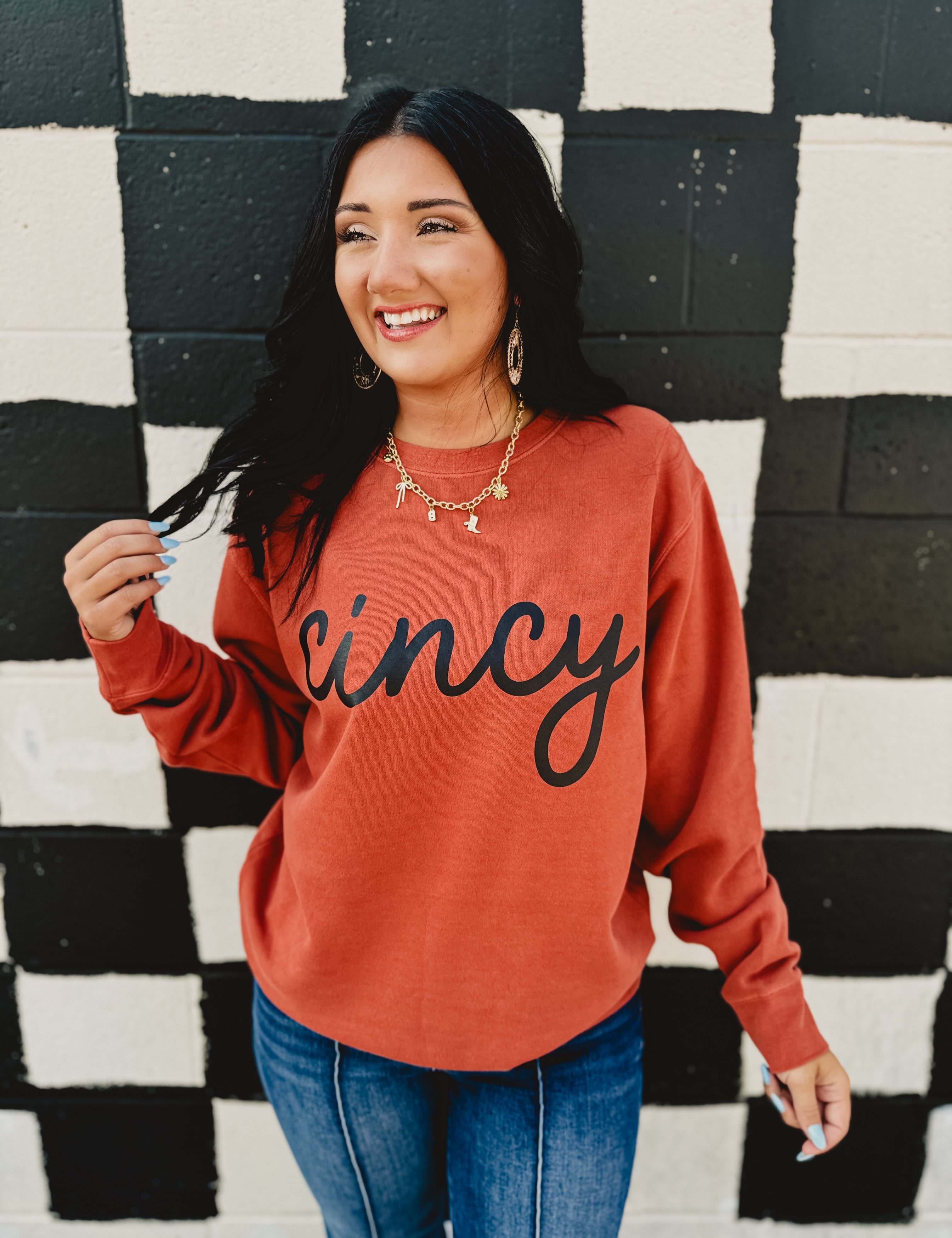 Long sleeve round neck orange Cincy sweatshirt.