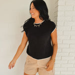Short sleeve knit sweater top with contrast colors in black and white.