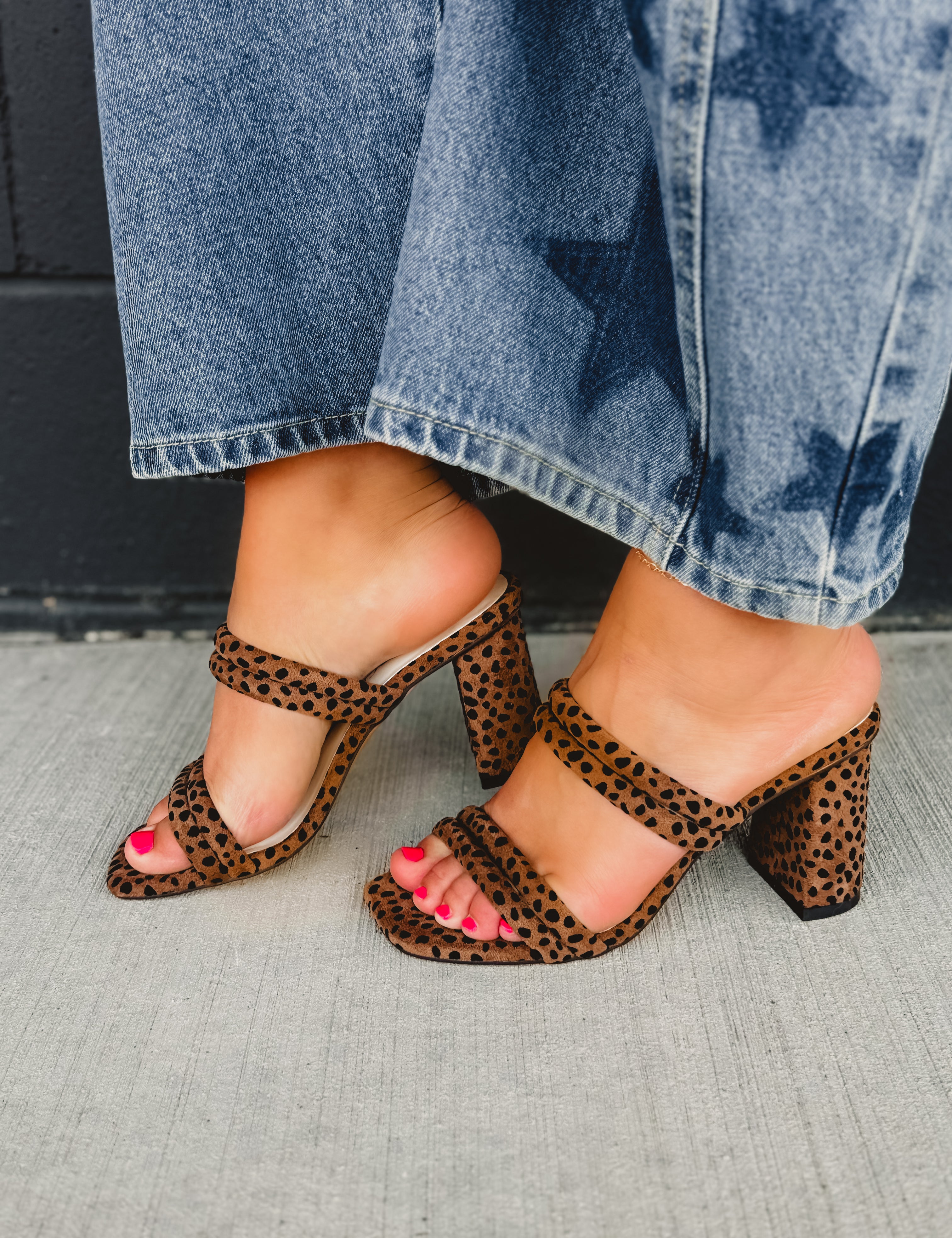 Leopard print high-heeled shoes with straps.