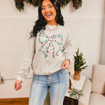 Christmas lights and bow embroidered heather grey sweatshirt.