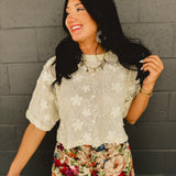 Lace floral embroidered sheer short sleeved drop shoulder top in cream.