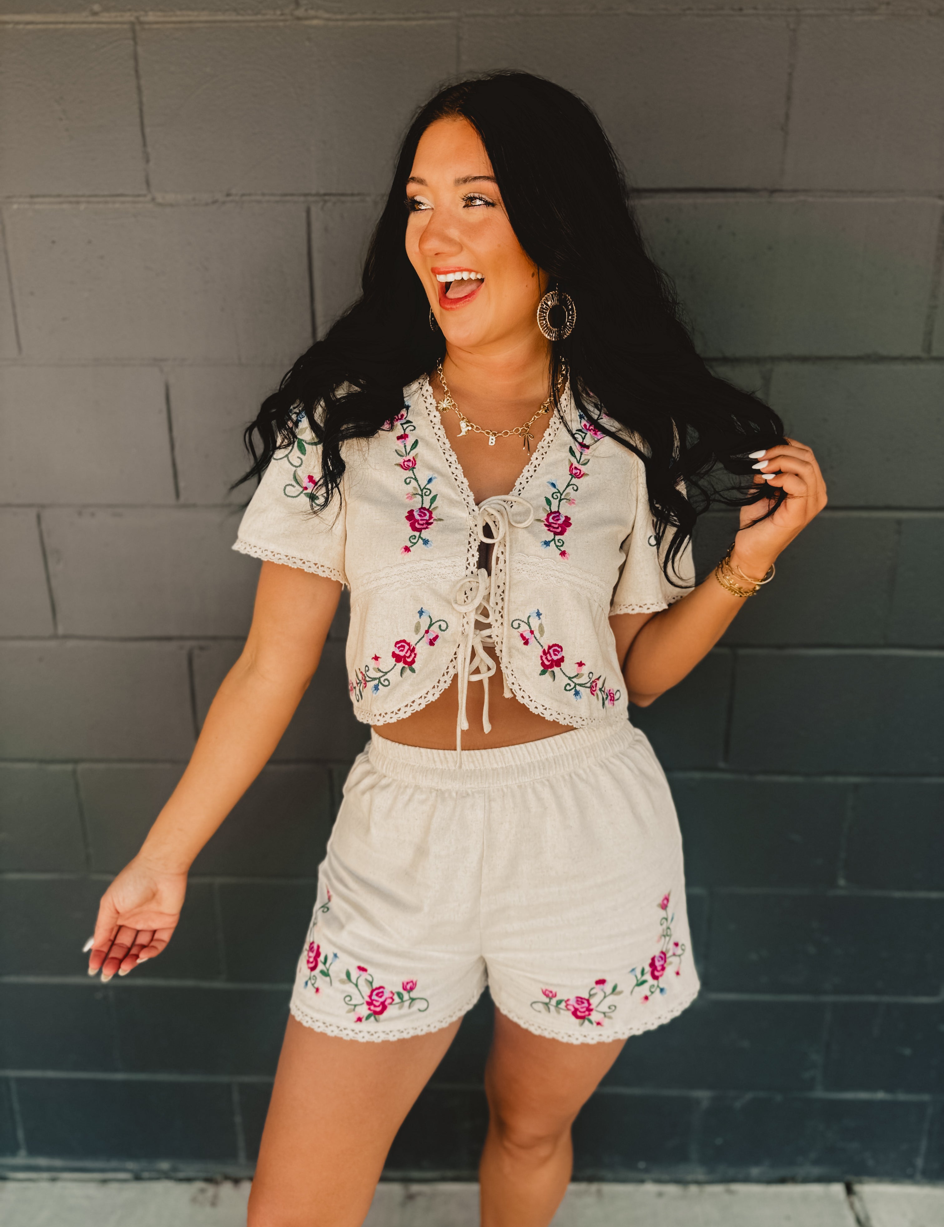 Short sleeved tie-up cropped blouse with floral embroidery and scalloped crochet details.