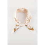 A floral printed peach colored scarf, bandana, etc.