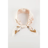 A floral printed peach colored scarf, bandana, etc.